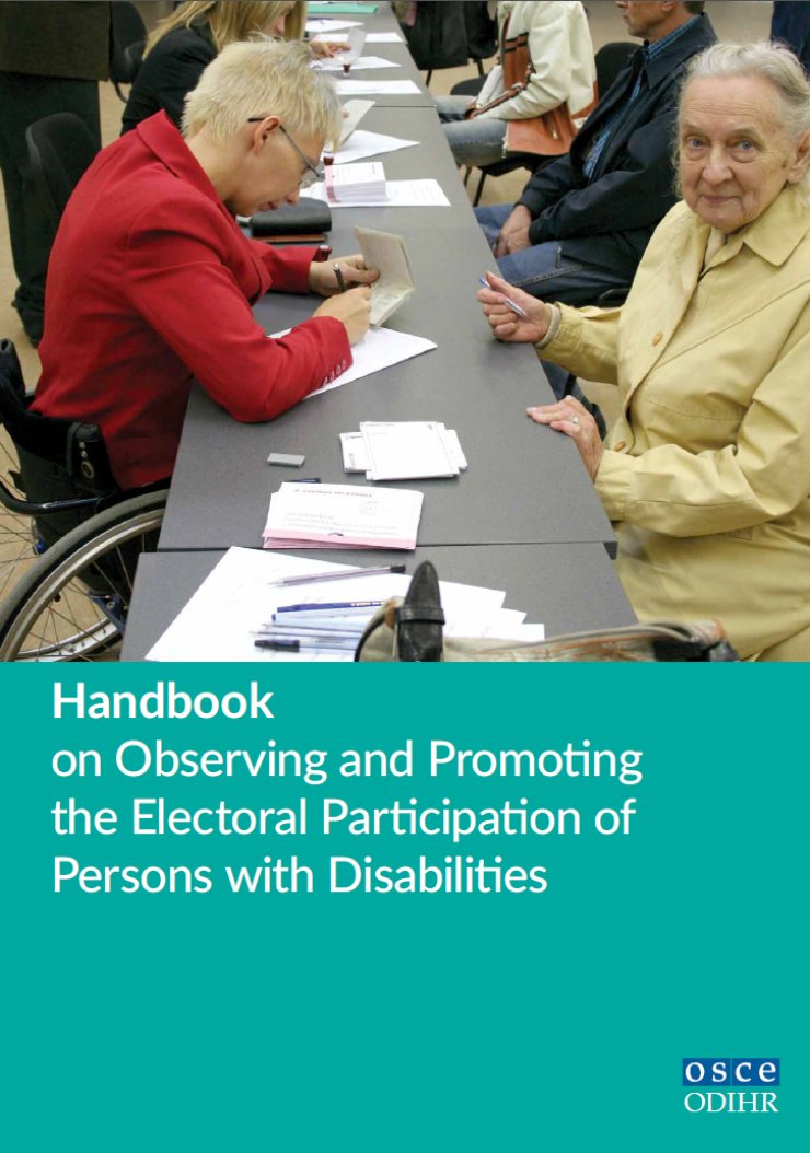 A woman using a wheelchair checks the voter registration of an older voter